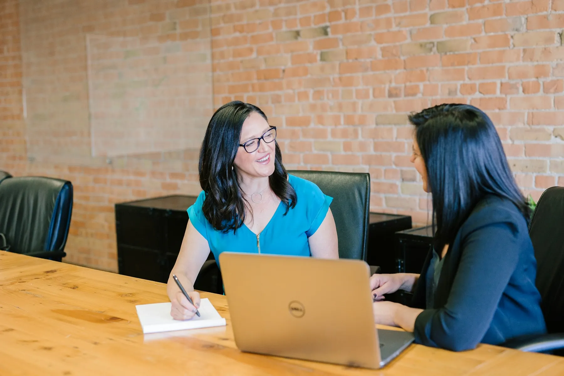 Small business team reviewing appointment scheduling software on a laptop