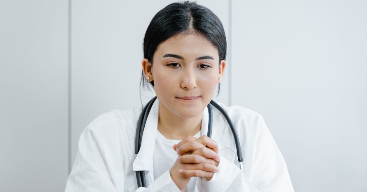 private clinic near me: clinic staff confirming a consultation fee and slot with a patient at the front desk