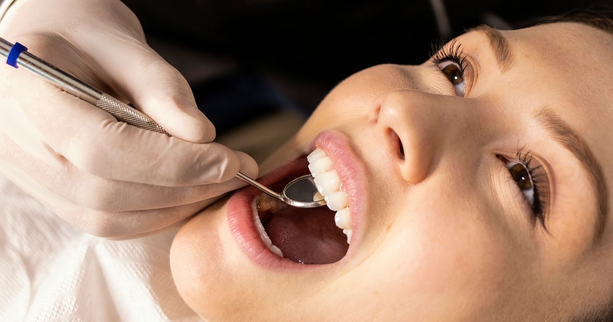 free dental care: dental clinic reception desk registering a patient at the counter