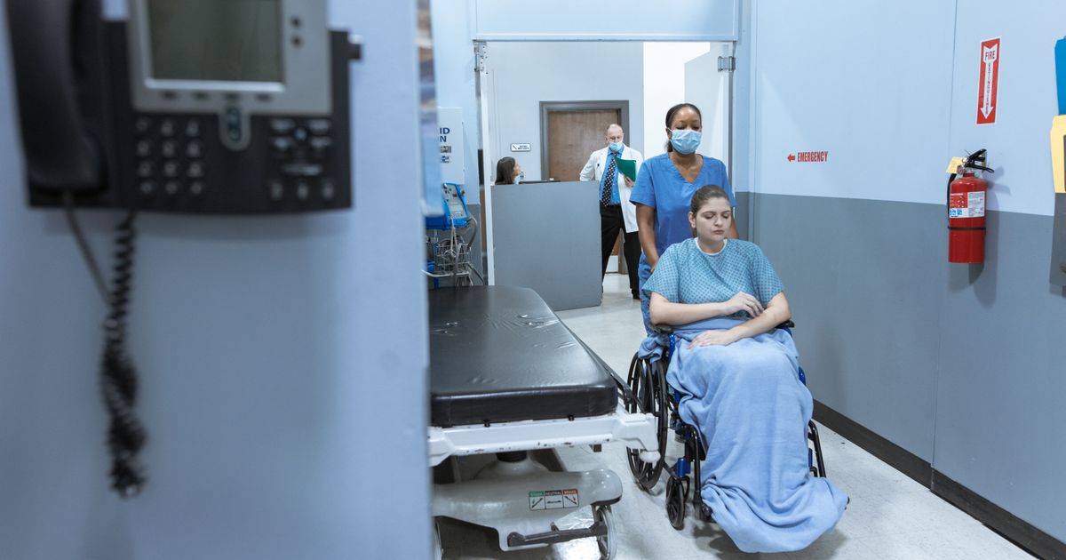weight loss doctors near me: nurse guiding a patient through a clinic corridor towards a consultation room