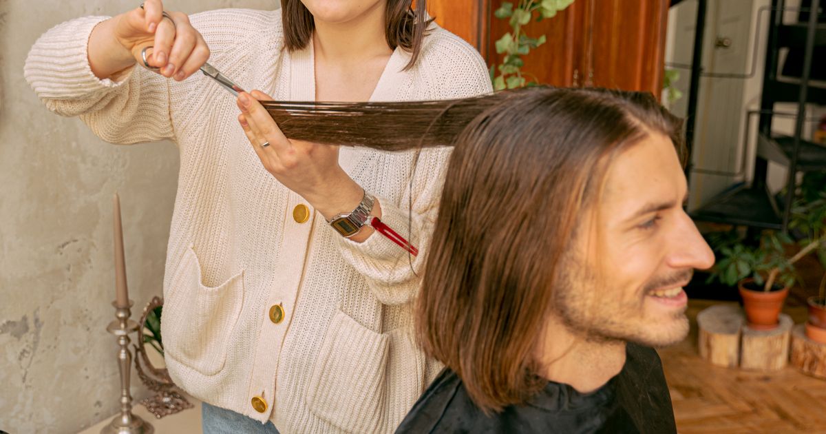 hair and beauty: client with long styled hair photographed at a salon before a combined service