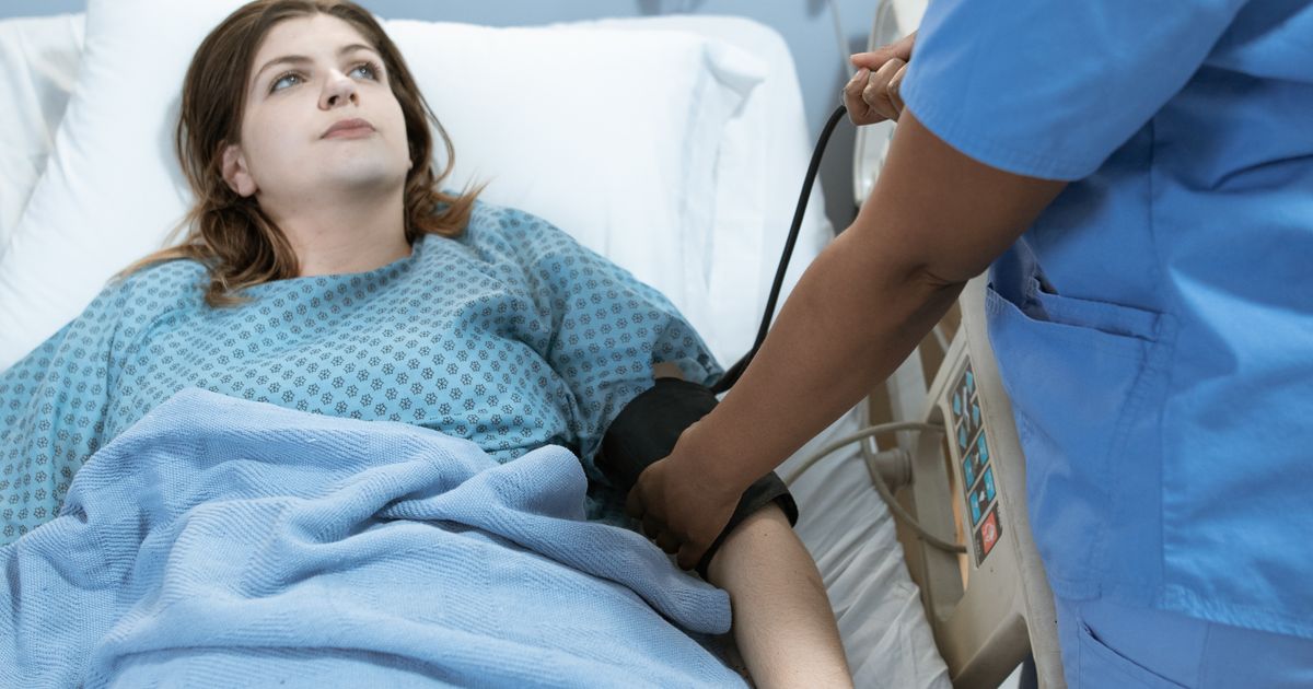 vein clinic near me: patient scanning a QR code at a specialist clinic check-in kiosk