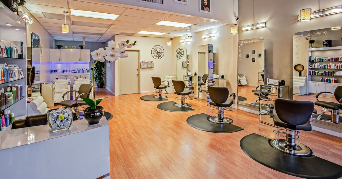 salon appointment app: customer booking a haircut slot on phone via QR code at salon entrance